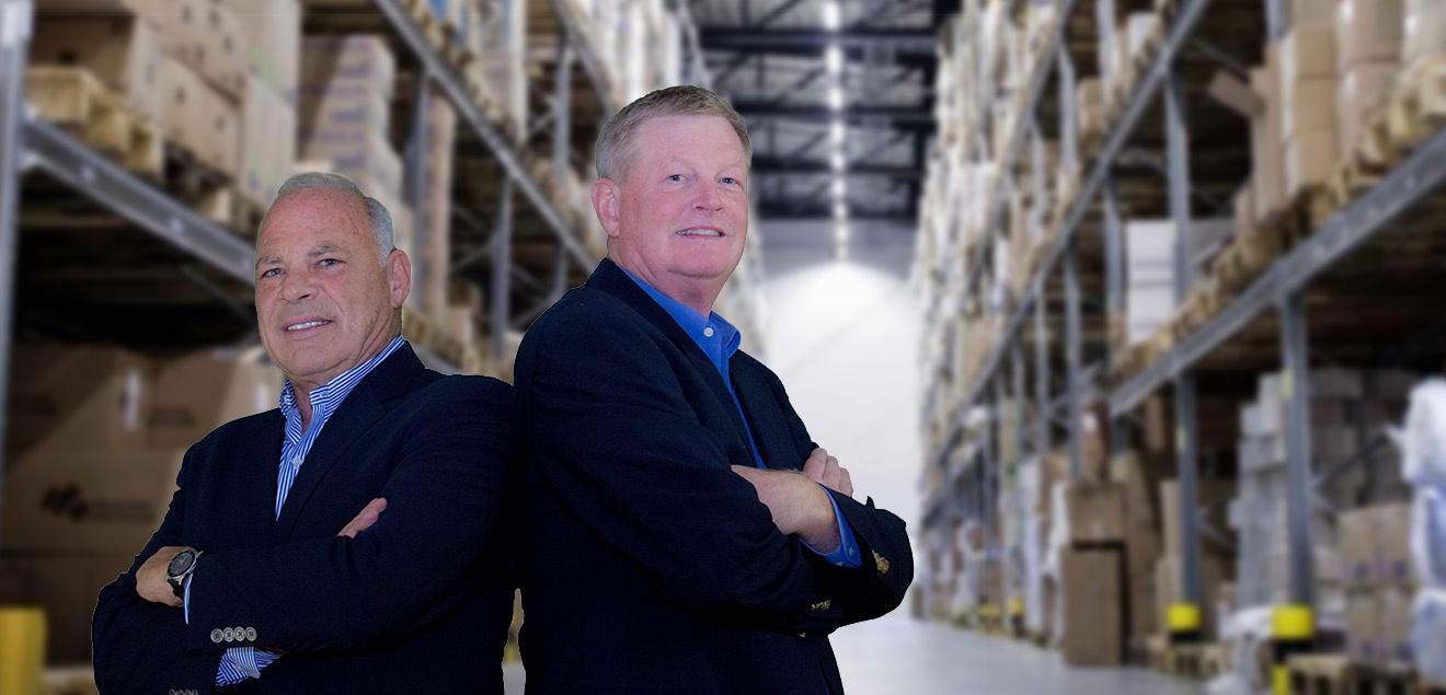 Bob and David Standing at a Facilities Service area Both Premier Facilities Services CEO's stand and pose in clean factory.
